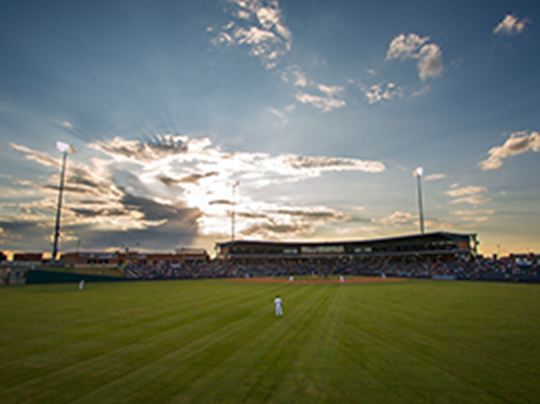 Sunset behind baseball stadium